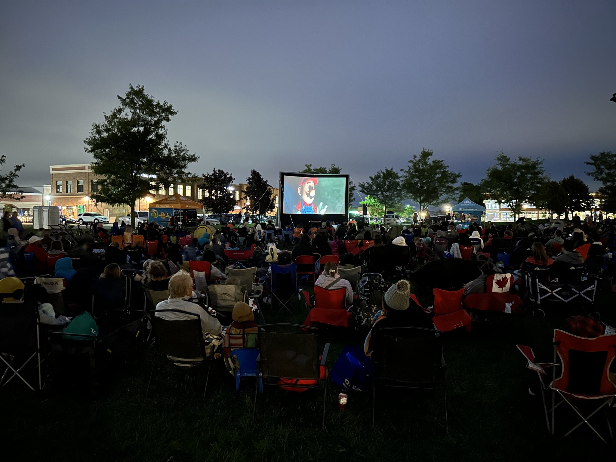 families watching outdoor movie