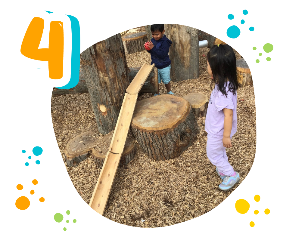 children rolling a ball down a ramp