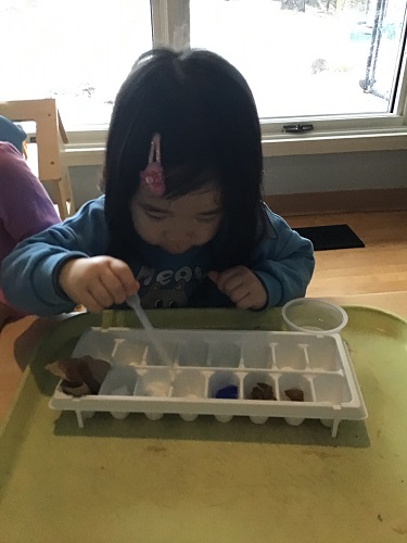 child using object at table