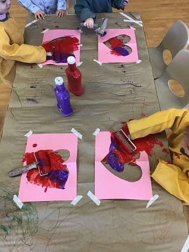Toddlers creating their banner together