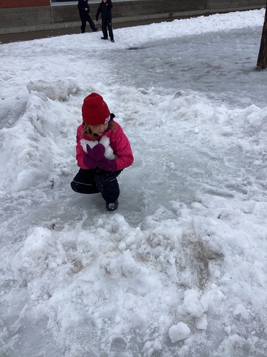 school-age child collecting boulders