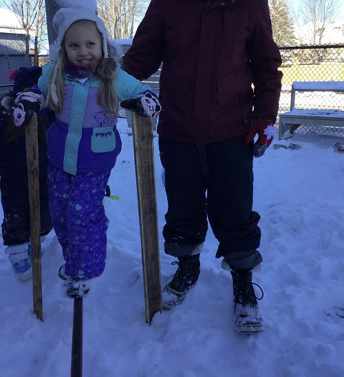 Preschool girls balancing on the ratchet straps