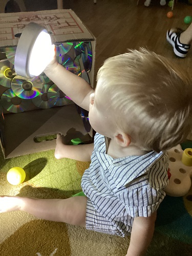 A child holding a puck light up to look at it