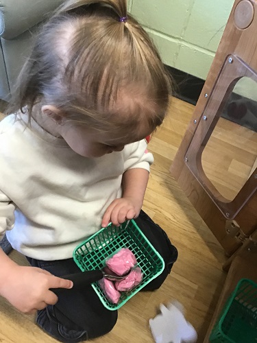 A child scooping tissue paper ice cream