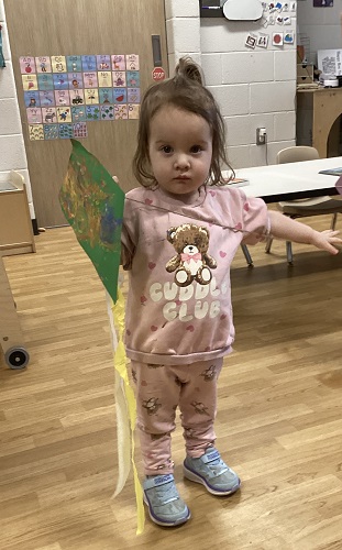 A child holding a kite she made