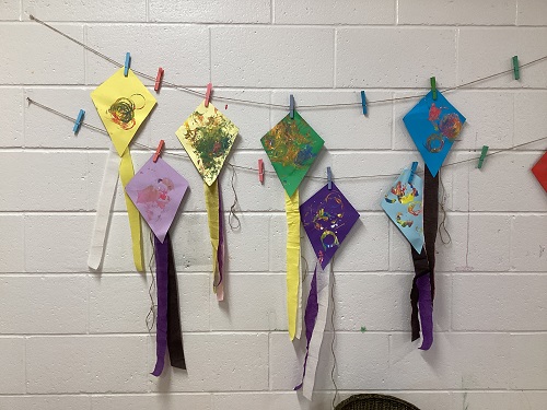 Child made kites lining the wall