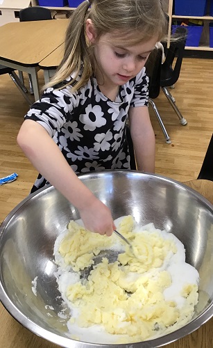 A child mixing ingredients in a large bowl
