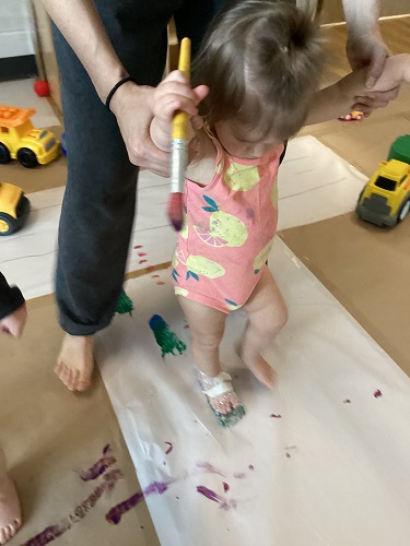 A child walking with bubble wrap on her foot