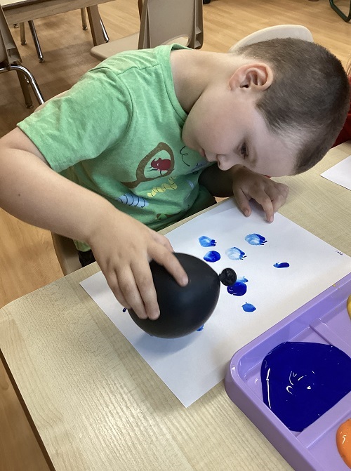 A preschool child mixing cookie dough