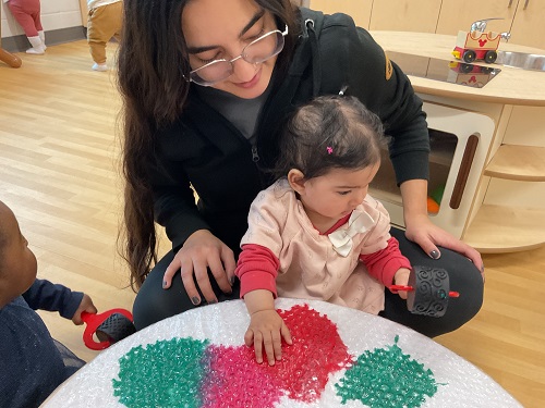 child and educator bubble wrap paint