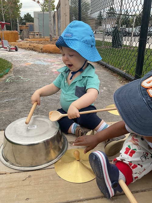 happy little guy playing the drums