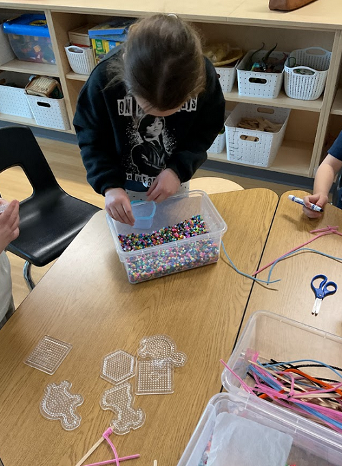 child choosing beads