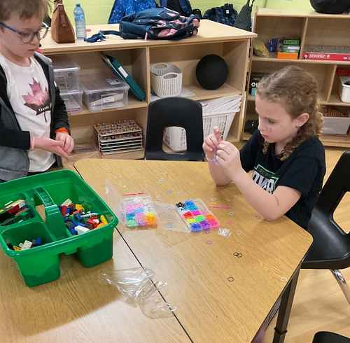 a couple children beading