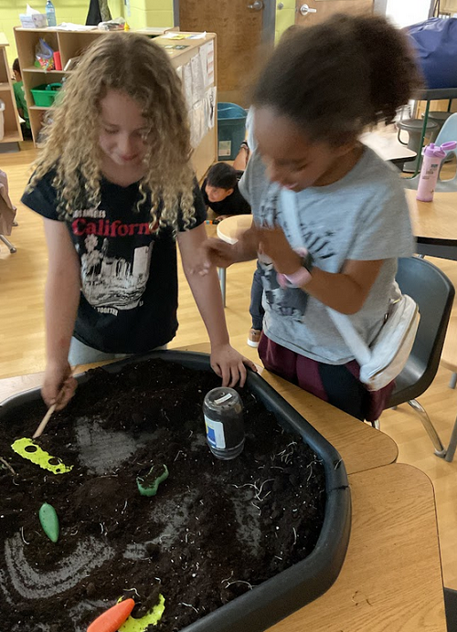 2 children potting grass