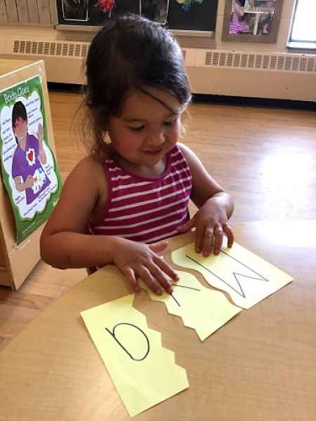girl doing a name puzzle