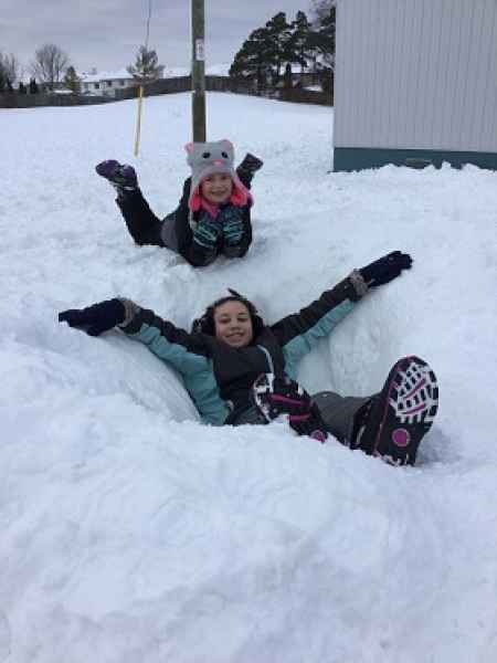 children laying in the snow