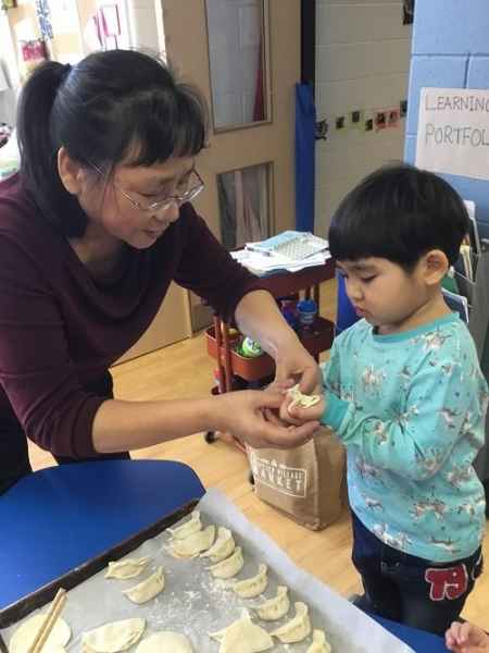 child and eductor making dumplings