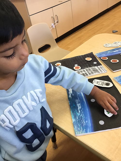 child doing a space themed activity