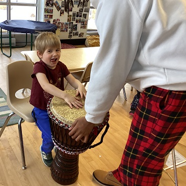 child playing a drum