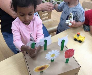girl making a paper flower garden