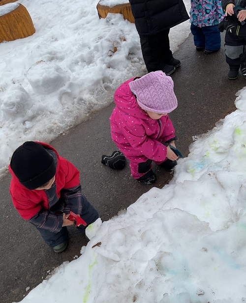 This month’s snow and colour exploration built on the toddlers’ interests in sensory play and winter experiences. Through painting on snow, mixing colours, and experimenting with spray bottles indoors and outdoors, the children explored cause and effect, colour recognition, and texture. They demonstrated growing independence, creativity, and problem-solving while strengthening fine motor skills and early language by naming colours and materials. The shared experiences encouraged cooperation, turn-taking, and peer interaction, highlighting the children’s confidence and joy in learning together through hands-on, play-based exploration. 