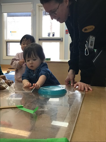 child reaches for object