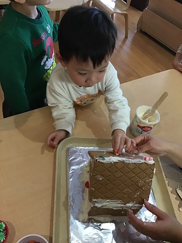 Child reaching for a cake