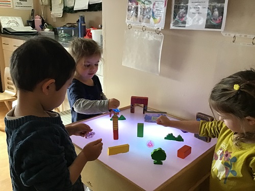Children around a light table