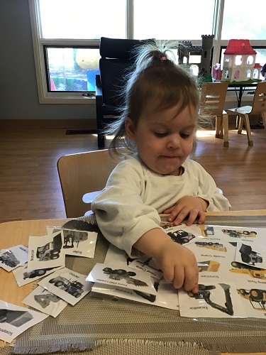 child looking through photos of buildings