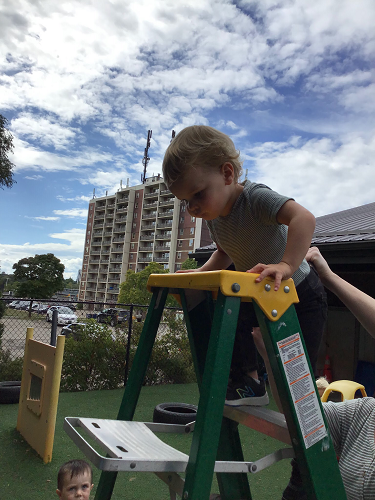 childing climbing a ladder