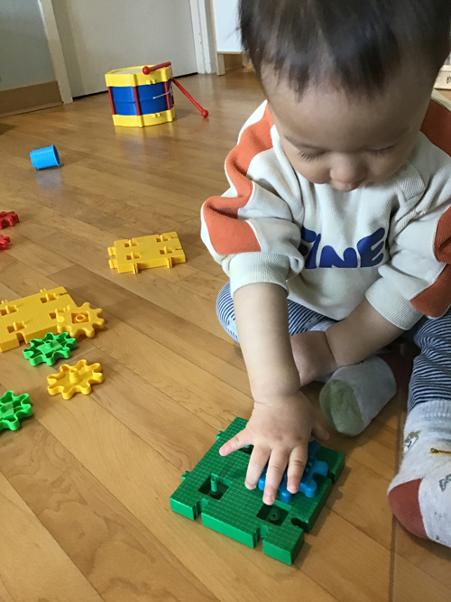 Child playing with a gear toy