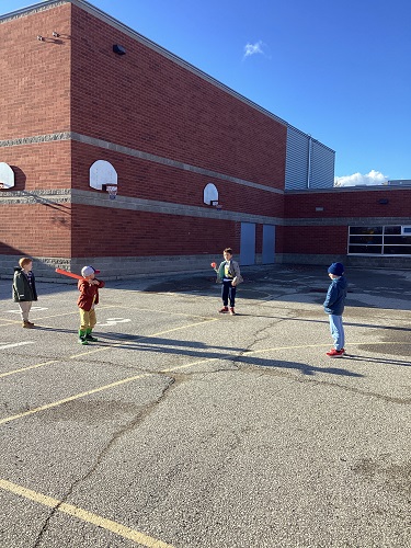 school age children playing baseball together