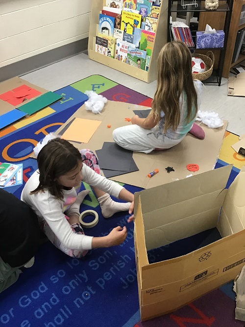 children working together on their halloween games