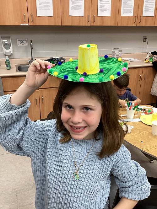 child with a sombrero on top of their head
