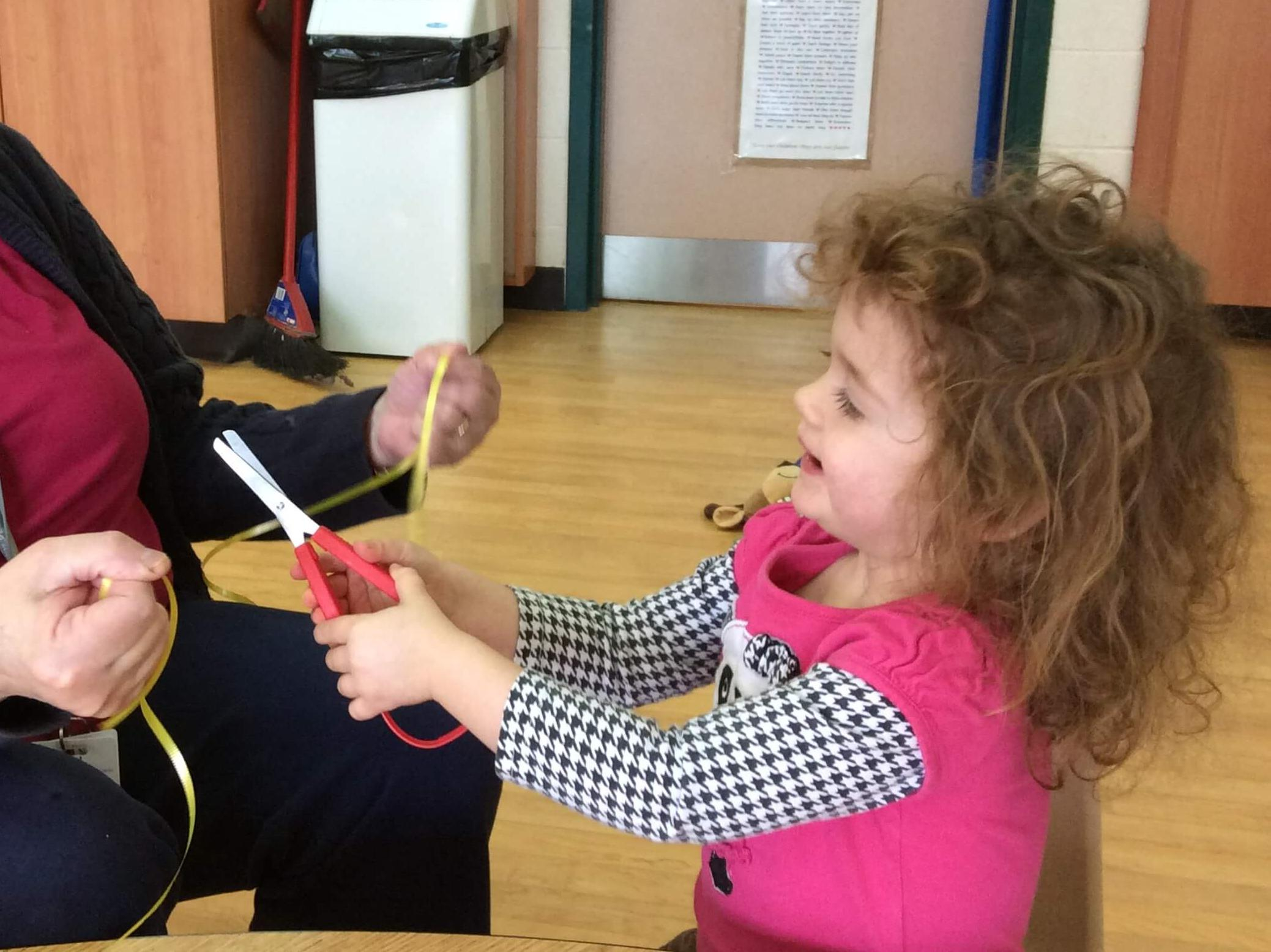 girl cutting a string