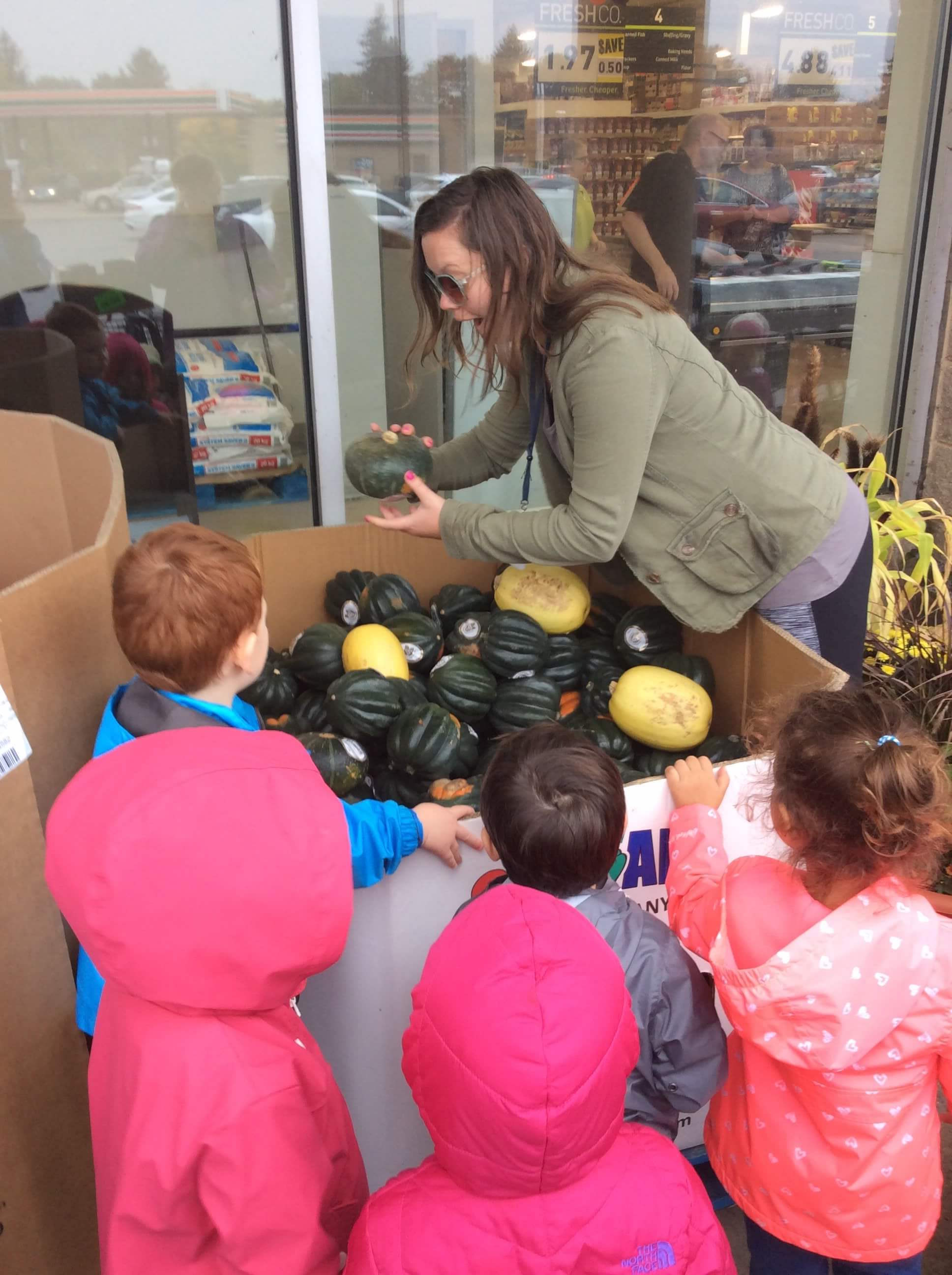 picking out gourds at a grocery store