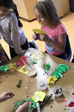 A child cutting a shape out of paper.
