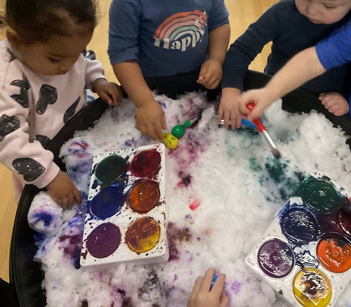 multiple children painting snow