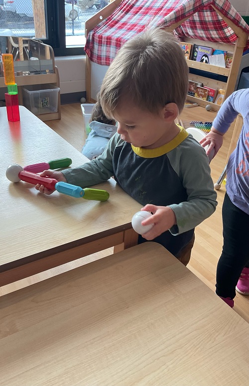Child figuring out how magnets work