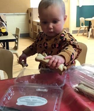 child holding a dog treat