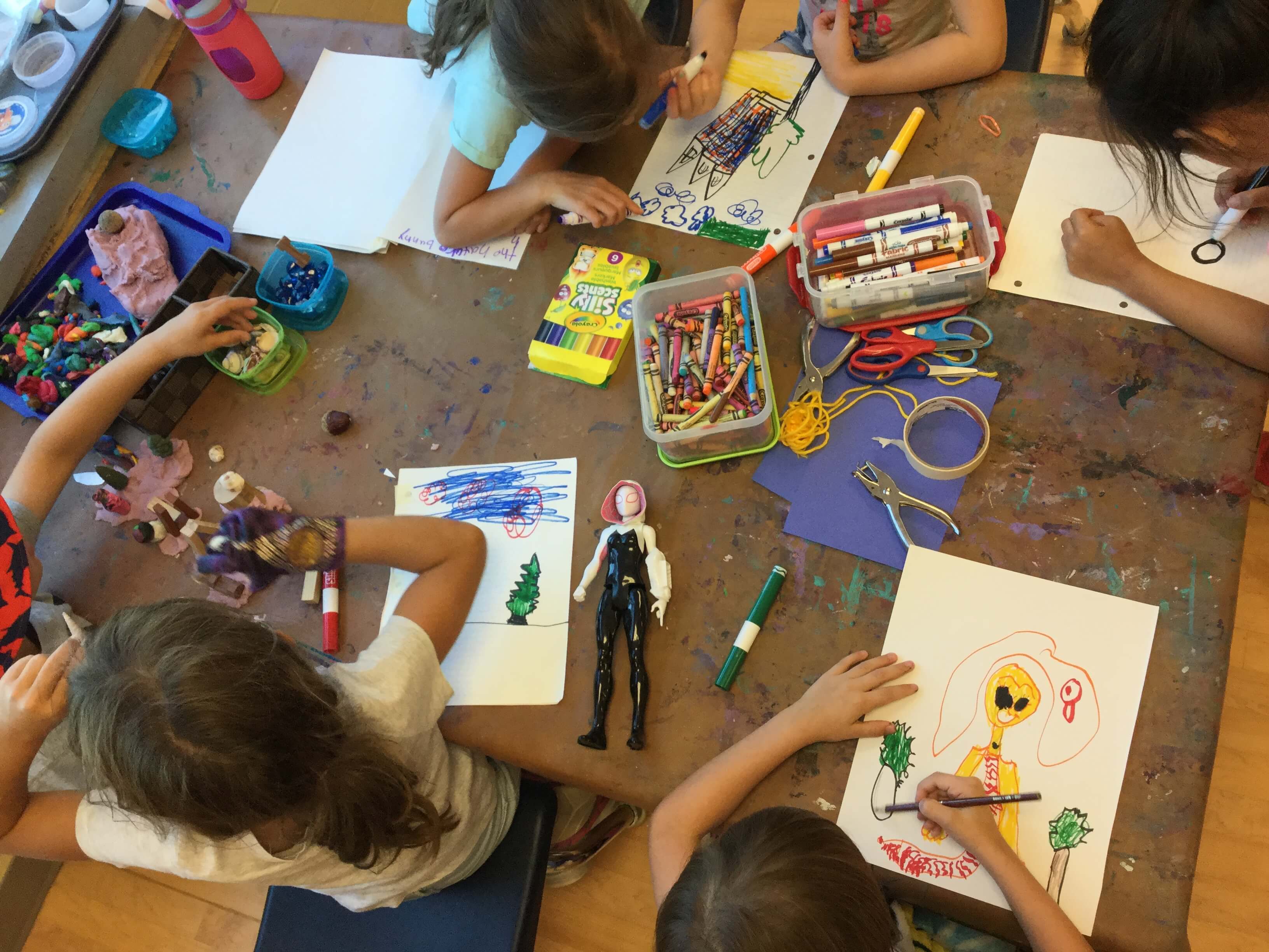 children drawing at a table
