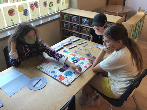 kids playing the board game they made up