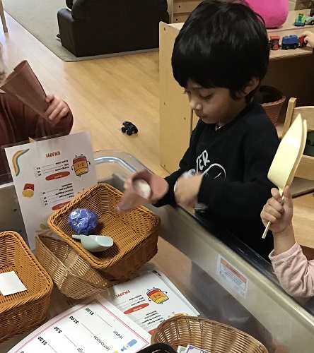 A child scooping ice cream into a cone