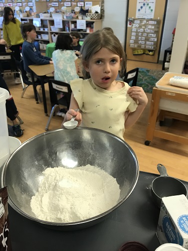 Adding ingredients to a big mixing bowl